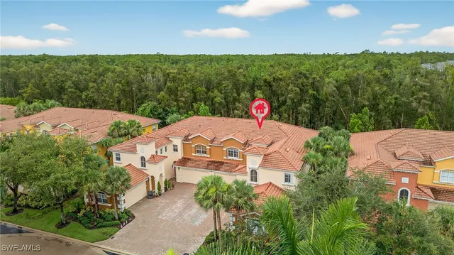 an aerial view of a house with yard and green space
