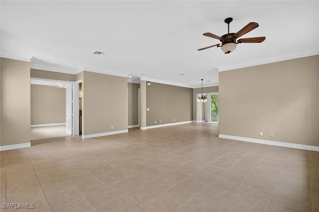 a view of a livingroom with a ceiling fan and window