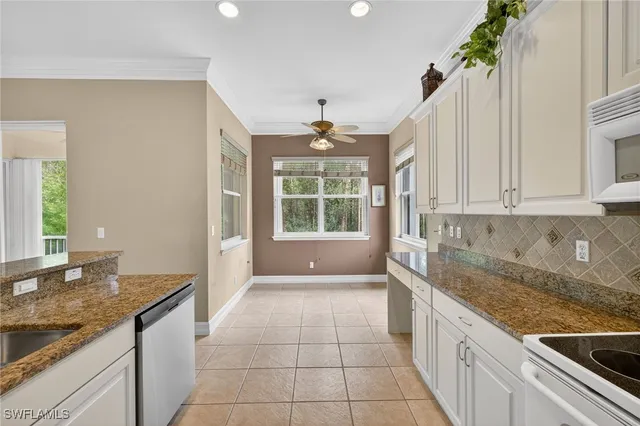 a large kitchen with granite countertop a sink and a stove