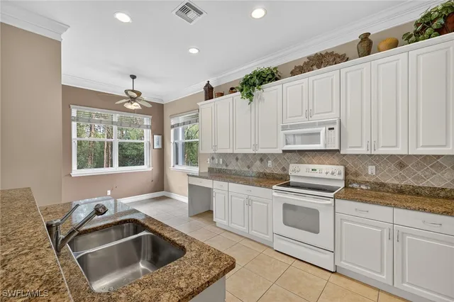 a kitchen that has a sink and a stove