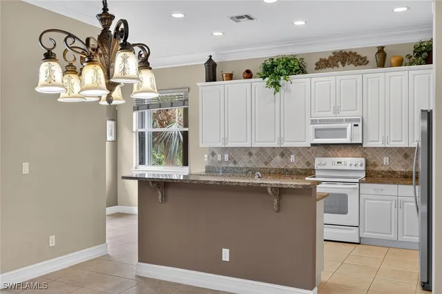 a kitchen with stainless steel appliances granite countertop a sink and cabinets