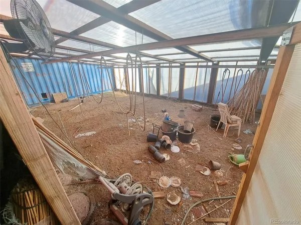 a view of water heater room with wooden floor