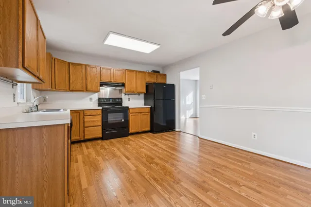 a kitchen with granite countertop a refrigerator and a sink