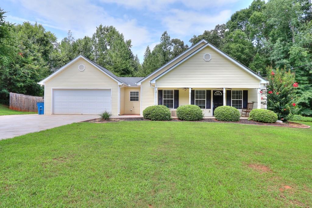 165 Autumn Court Covington, GA 30016 - Photo 1 of 1 a view of a house with a yard and potted plants
