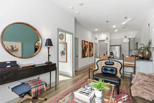 a living room with furniture and a mirror
