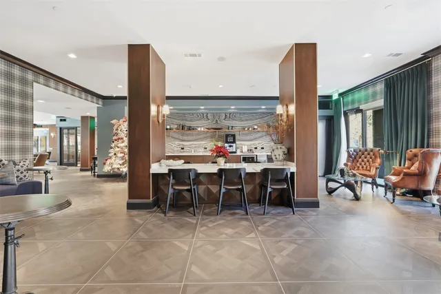 a living room with furniture and a floor to ceiling window