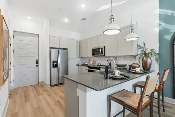 a kitchen with refrigerator and cabinets