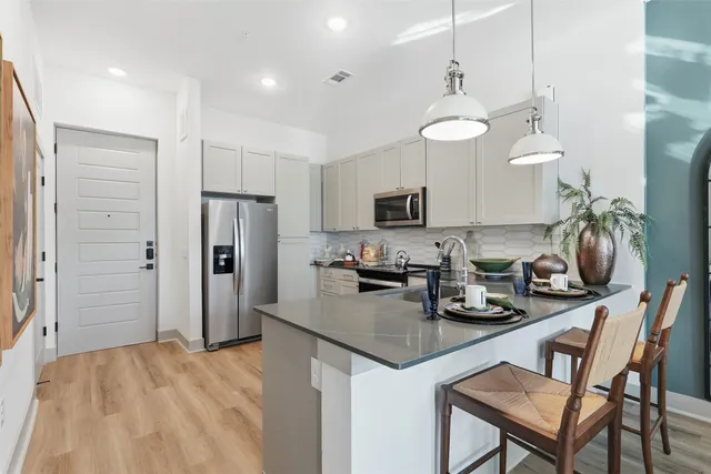 a kitchen with refrigerator and cabinets