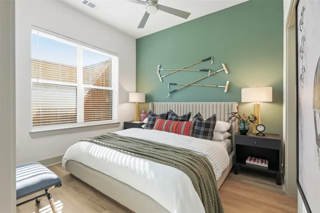 a bedroom with a bed and a night stand