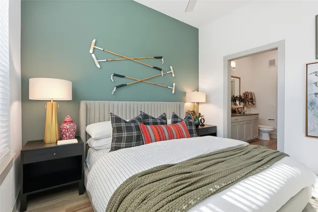 a bedroom with a bed and a lamp