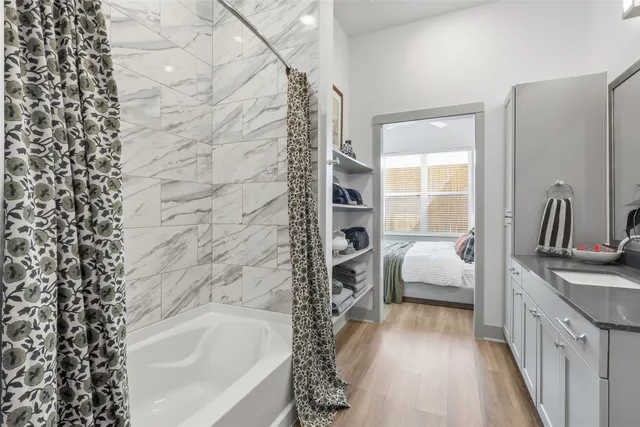 a bathroom with a bathtub and shower