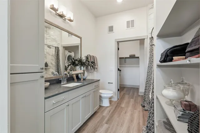 a bathroom with a sink a toilet and a mirror