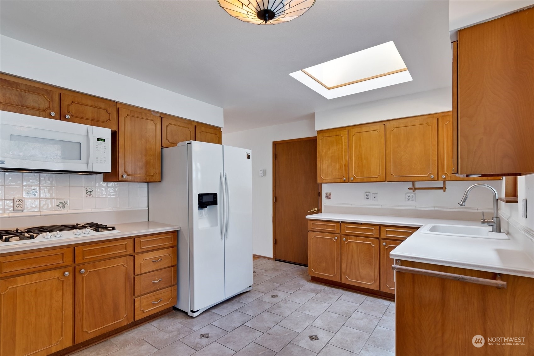 23331 19th Place West Bothell, WA 98021 - Photo 8 of 25 a kitchen with stainless steel appliances granite countertop a sink stove and refrigerator