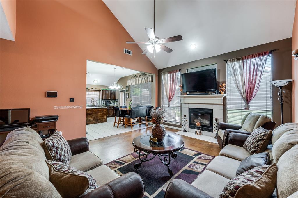 305 Ravenna Road Lake Dallas, TX 75065 - Photo 13 of 23 a living room with furniture a fireplace and a flat screen tv