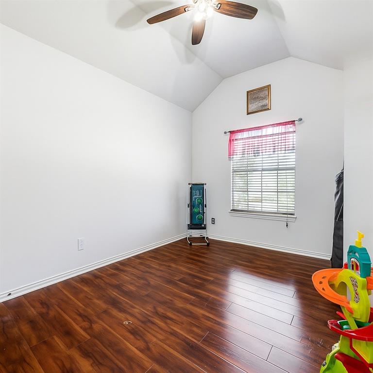 305 Ravenna Road Lake Dallas, TX 75065 - Photo 15 of 23 a view of an empty room with wooden floor and a window