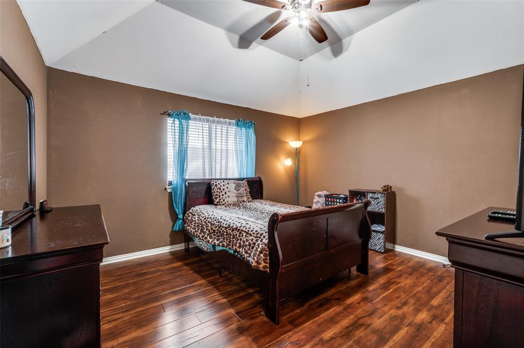 305 Ravenna Road Lake Dallas, TX 75065 - Photo 17 of 23 a bedroom with a bed and wooden floor