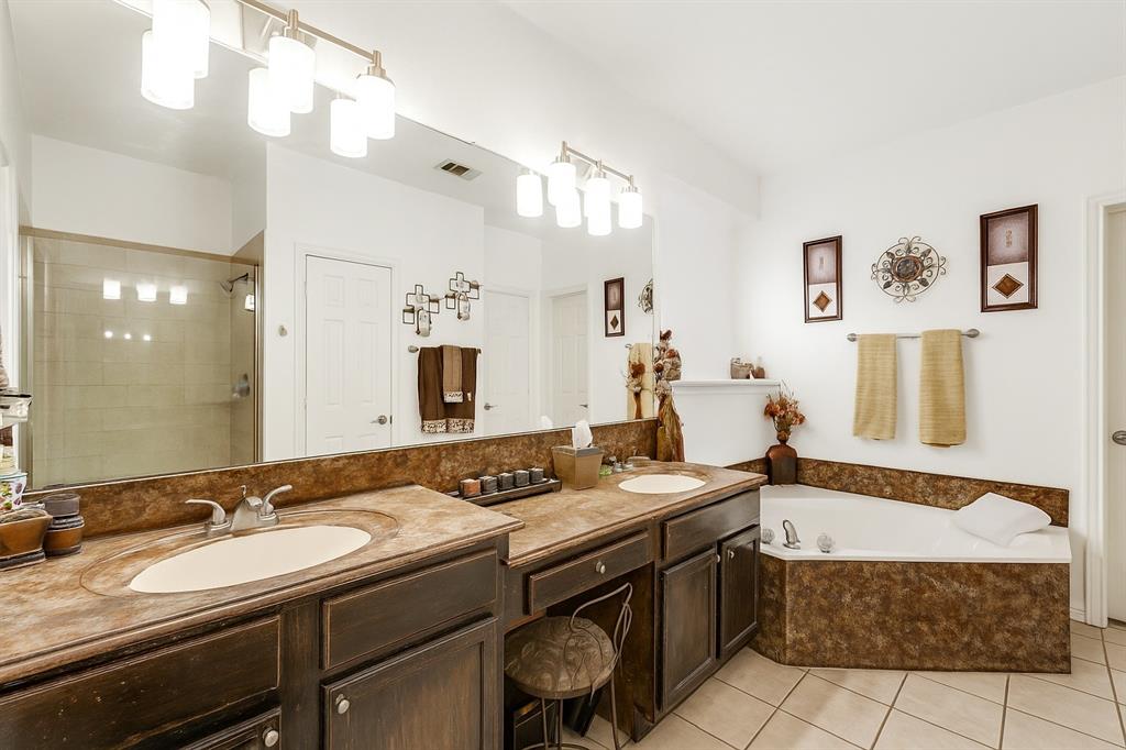 305 Ravenna Road Lake Dallas, TX 75065 - Photo 19 of 23 a spacious bathroom with a granite countertop sink a mirror and a bathtub