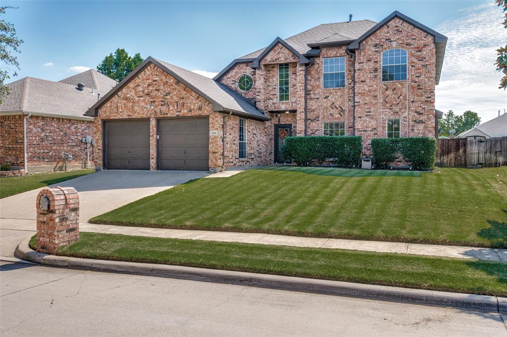 305 Ravenna Road Lake Dallas, TX 75065 - Photo 2 of 23 a front view of a house with a yard and garage