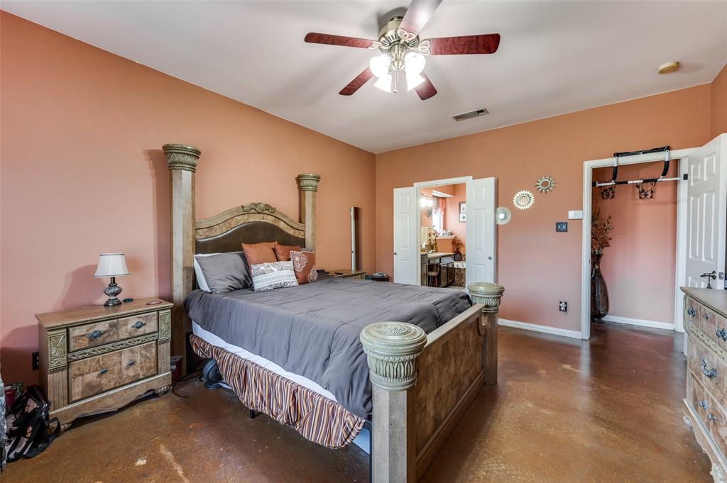 305 Ravenna Road Lake Dallas, TX 75065 - Photo 21 of 23 a bedroom with a bed and a chandelier