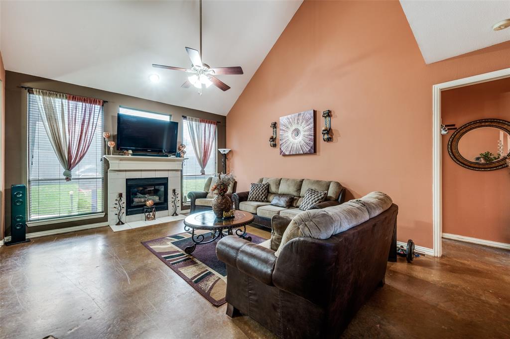 305 Ravenna Road Lake Dallas, TX 75065 - Photo 6 of 23 a living room with furniture a fireplace and a flat screen tv
