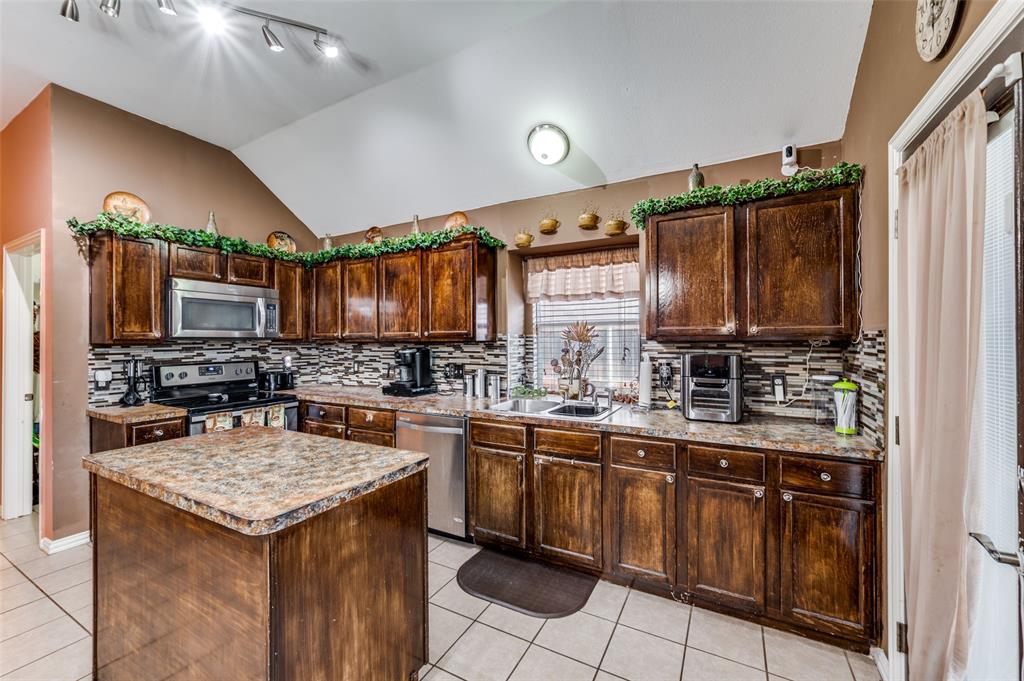 305 Ravenna Road Lake Dallas, TX 75065 - Photo 8 of 23 a kitchen with a sink stove and cabinets