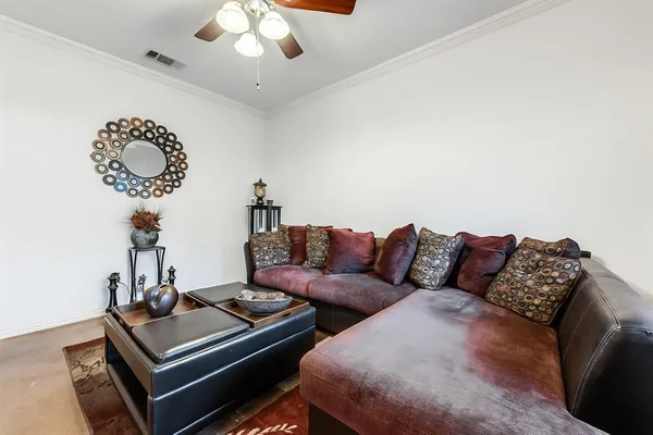 a living room with furniture and a chandelier