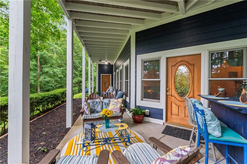 320 Holly Lane Walhalla, SC 29691 - Photo 37 of 41 This inviting porch offers a tranquil retreat surrounded by lush greenery and comfortable seating.