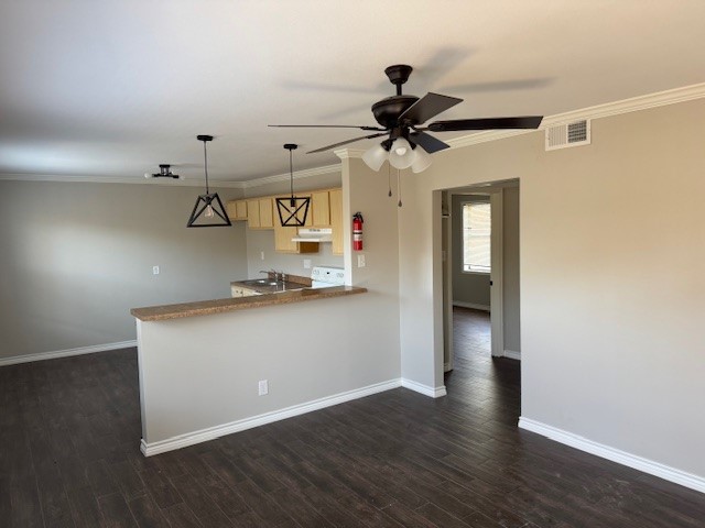 a living room with stainless steel appliances wooden floor