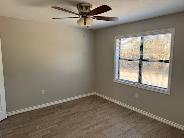3620 Southmore Boulevard, Unit 11 Houston, TX 77004 - Photo 8 of 15 an empty room with wooden floor fan and windows