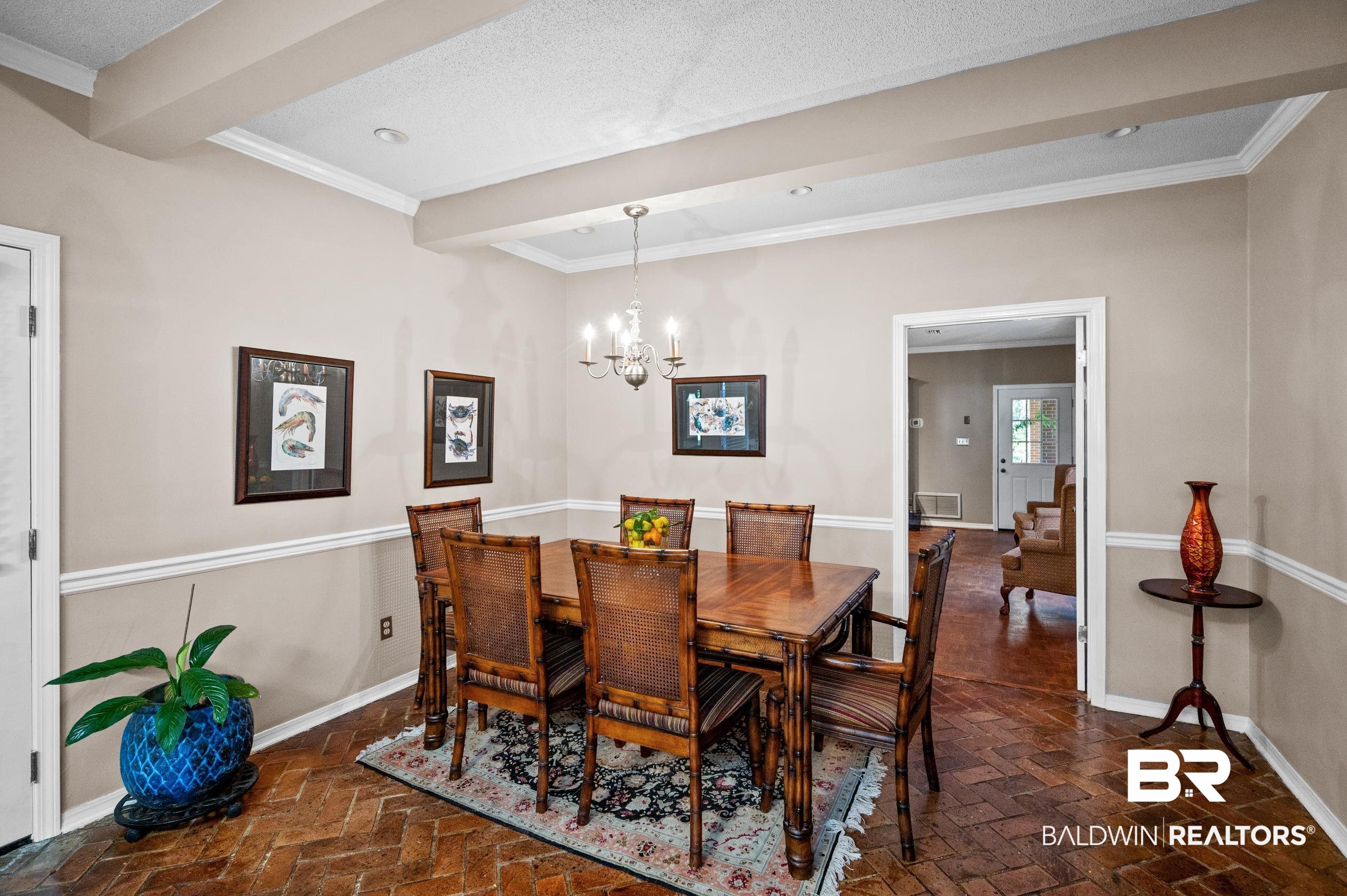 6705 Ridgeland Road South Mobile, AL 36695 - Photo 14 of 44 Dining space with beamed ceiling, crown molding, a textured ceiling, and an inviting chandelier