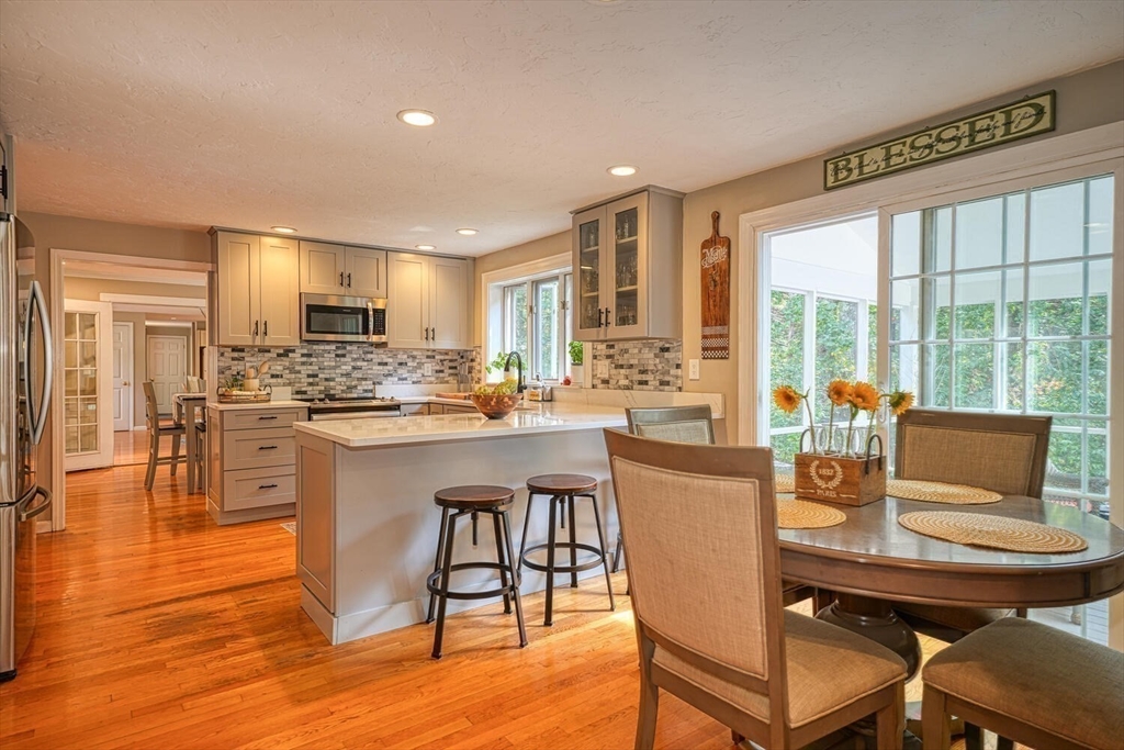 3 Pheasanthill Road Norfolk, MA 02056 - Photo 13 of 32 a kitchen with a table chairs refrigerator and cabinets