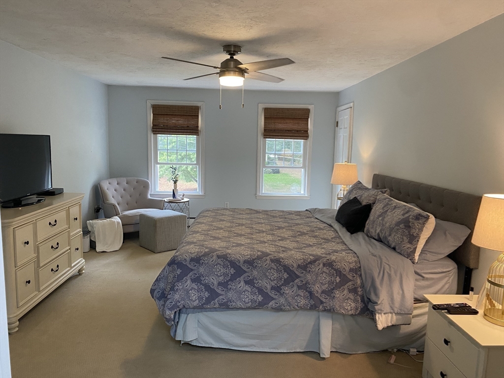 3 Pheasanthill Road Norfolk, MA 02056 - Photo 16 of 32 a bedroom with a large bed and flat tv screen on a dresser