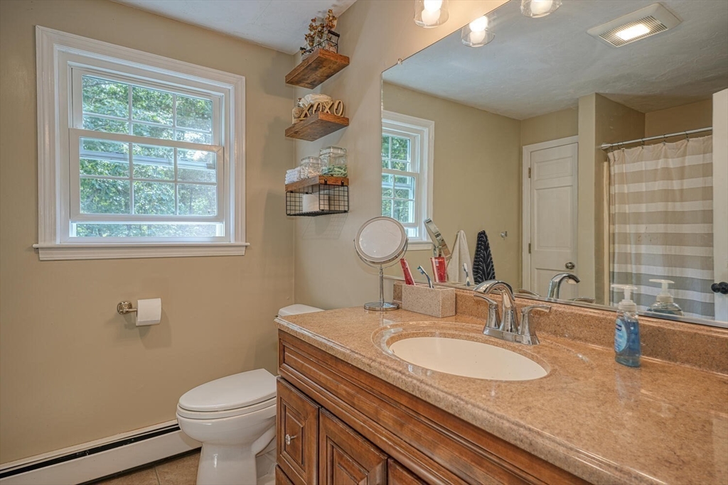3 Pheasanthill Road Norfolk, MA 02056 - Photo 21 of 32 a bathroom with a granite countertop toilet a sink and a mirror