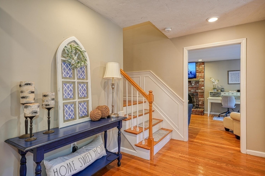 3 Pheasanthill Road Norfolk, MA 02056 - Photo 3 of 32 a view of a hallway with wooden floor and furniture