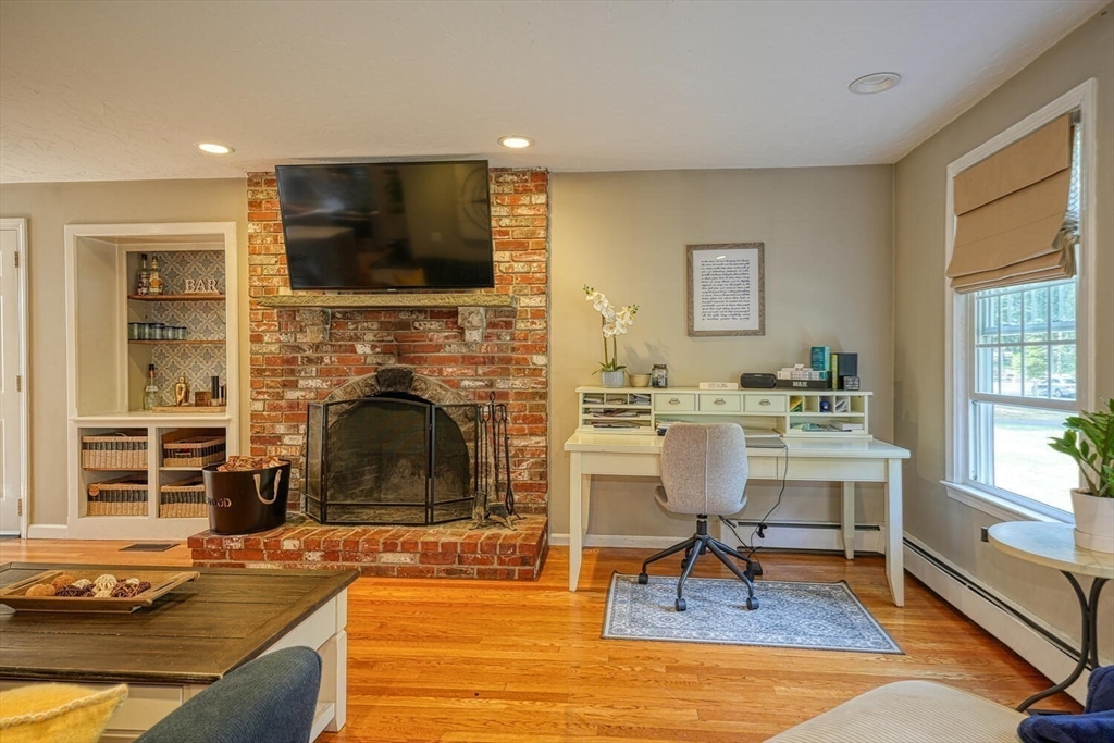 3 Pheasanthill Road Norfolk, MA 02056 - Photo 5 of 32 a living room with furniture a flat screen tv and a fireplace