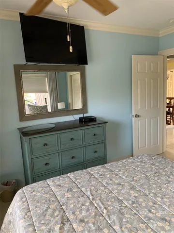 a bedroom with a bed and a mirror on dresser