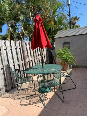 a view of a backyard with furniture and outdoor seating
