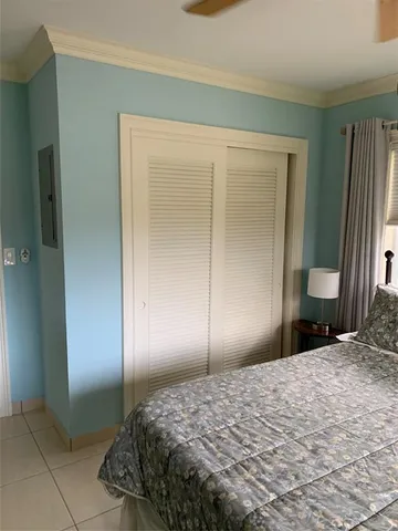 a bedroom with a bed and a mirror