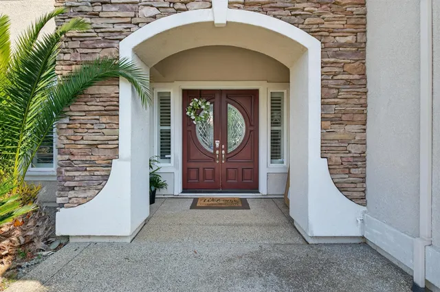 a living room with furniture and a view of kitchen