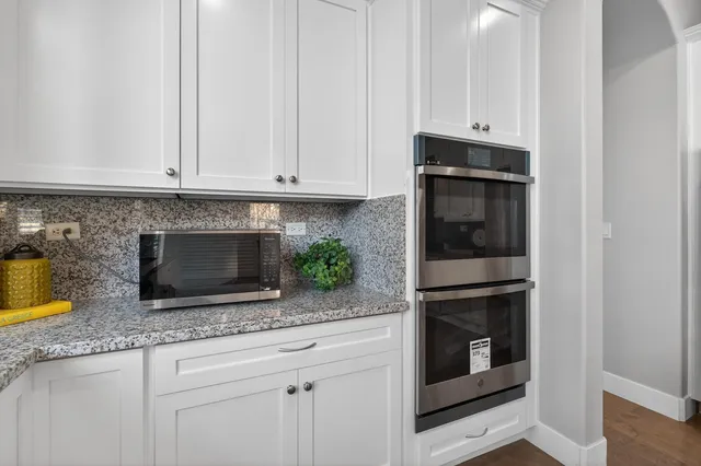 a view of a hallway with wooden floor and stairs