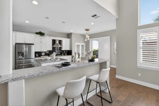 an empty room with wooden floor and a ceiling fan