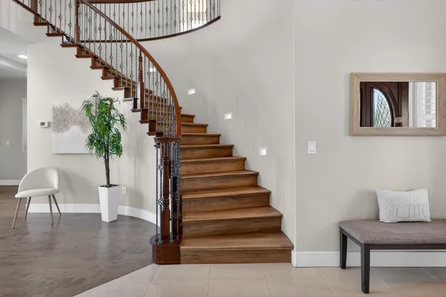 a view of a room with wooden floor and a ceiling fan