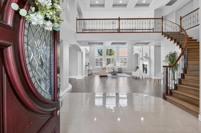 a dining room with furniture potted plants and wooden floor