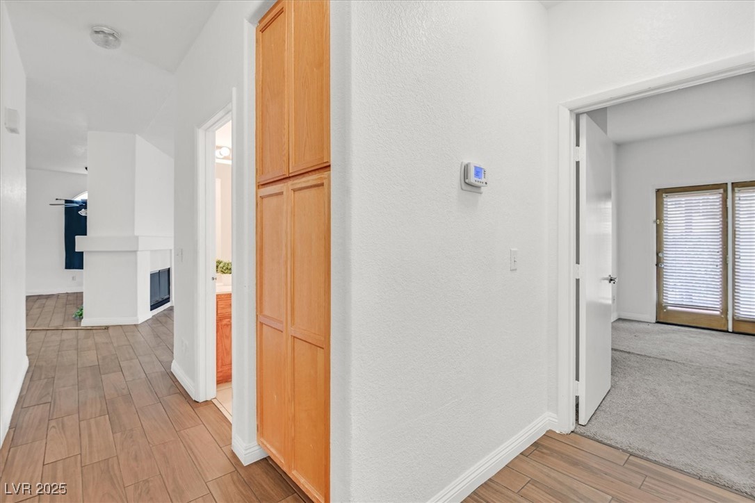 731 Rising Star Drive Henderson, NV 89014 - Photo 11 of 25 Corridor with light wood-type flooring, baseboards, and a textured wall
