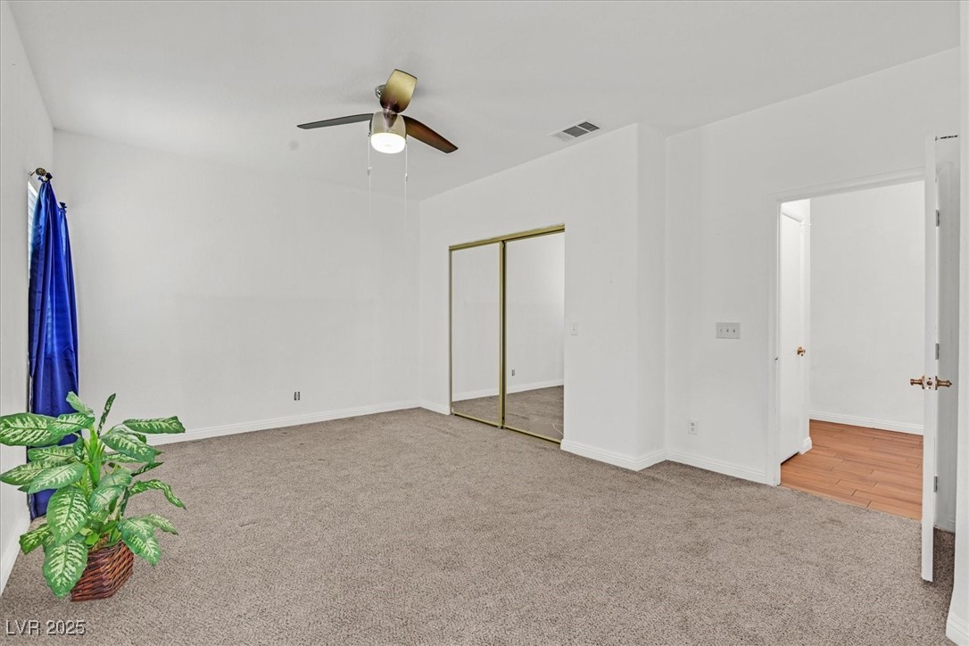 731 Rising Star Drive Henderson, NV 89014 - Photo 13 of 25 Unfurnished bedroom featuring carpet, baseboards, a closet, and a ceiling fan