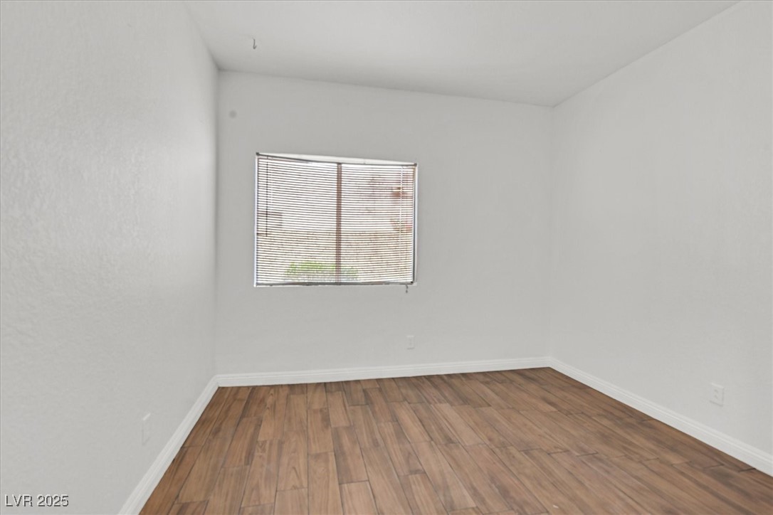 731 Rising Star Drive Henderson, NV 89014 - Photo 17 of 25 Unfurnished room with wood finished floors and baseboards