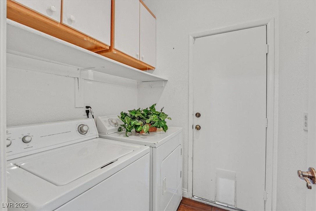 731 Rising Star Drive Henderson, NV 89014 - Photo 20 of 25 Washroom featuring separate washer and dryer, cabinet space, and dark wood-type flooring