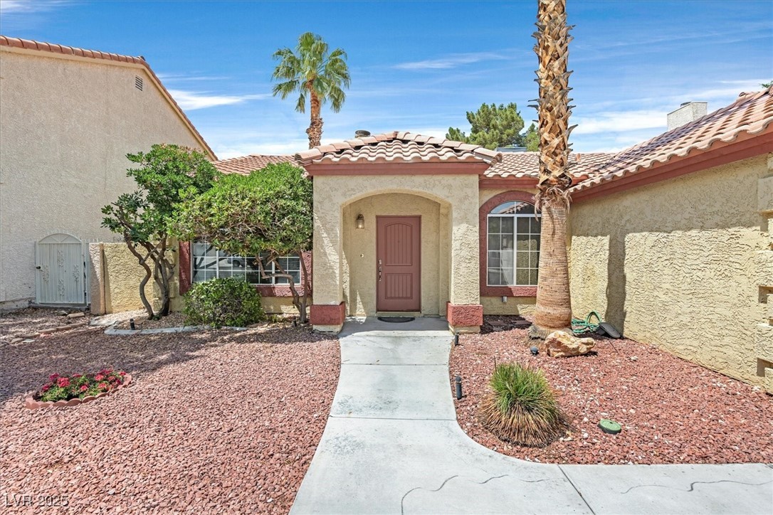 731 Rising Star Drive Henderson, NV 89014 - Photo 2 of 25 Property entrance with stucco siding and a tile roof