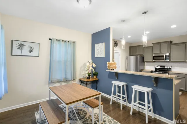 a kitchen with stainless steel appliances granite countertop a refrigerator a stove top oven a sink and dishwasher