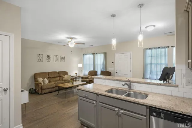 a living room with furniture and a sink